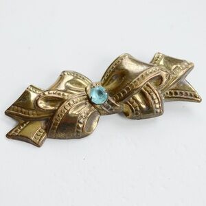 1940’s Elegant Gold tone Brass Bow Brooch with Blue Gem